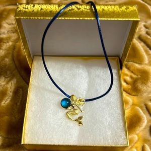 Beautiful mermaid with blue stone